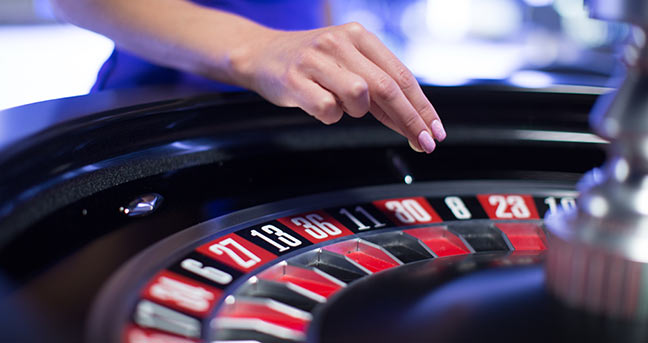 Roulette Wheel and the dealer hand with the roulette ball